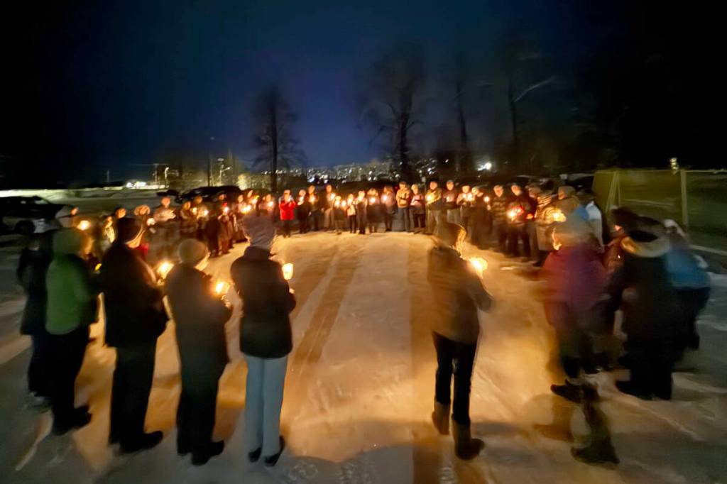Congregants of the Island Gospel Fellowship gather in the parking lot of their church, which was destroyed by fire on Dec. 22, to give thanks for God&rsquo;s grace and pray for the youth who allegedly started the fire. (Island Gospel Fellowship/Submitted)